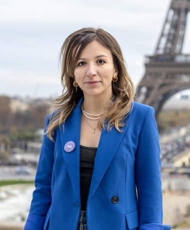 Francesca Romana D'Antuono, Co-President of Volt Europa, smiles in front of the Tour Eiffel