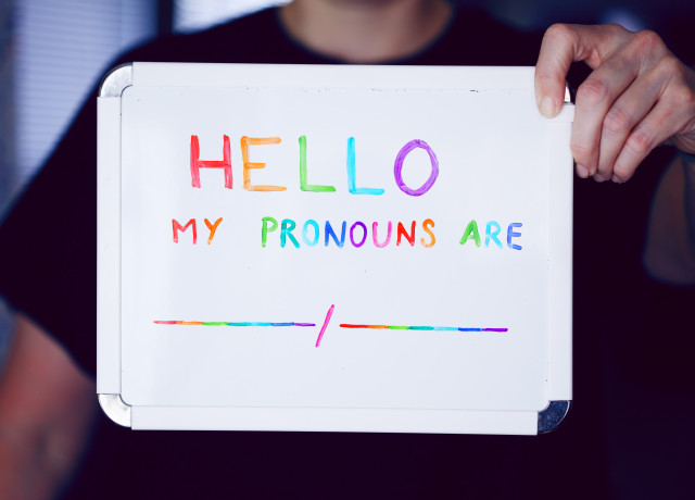 A sign that reads, 'Hello, my pronouns are...'