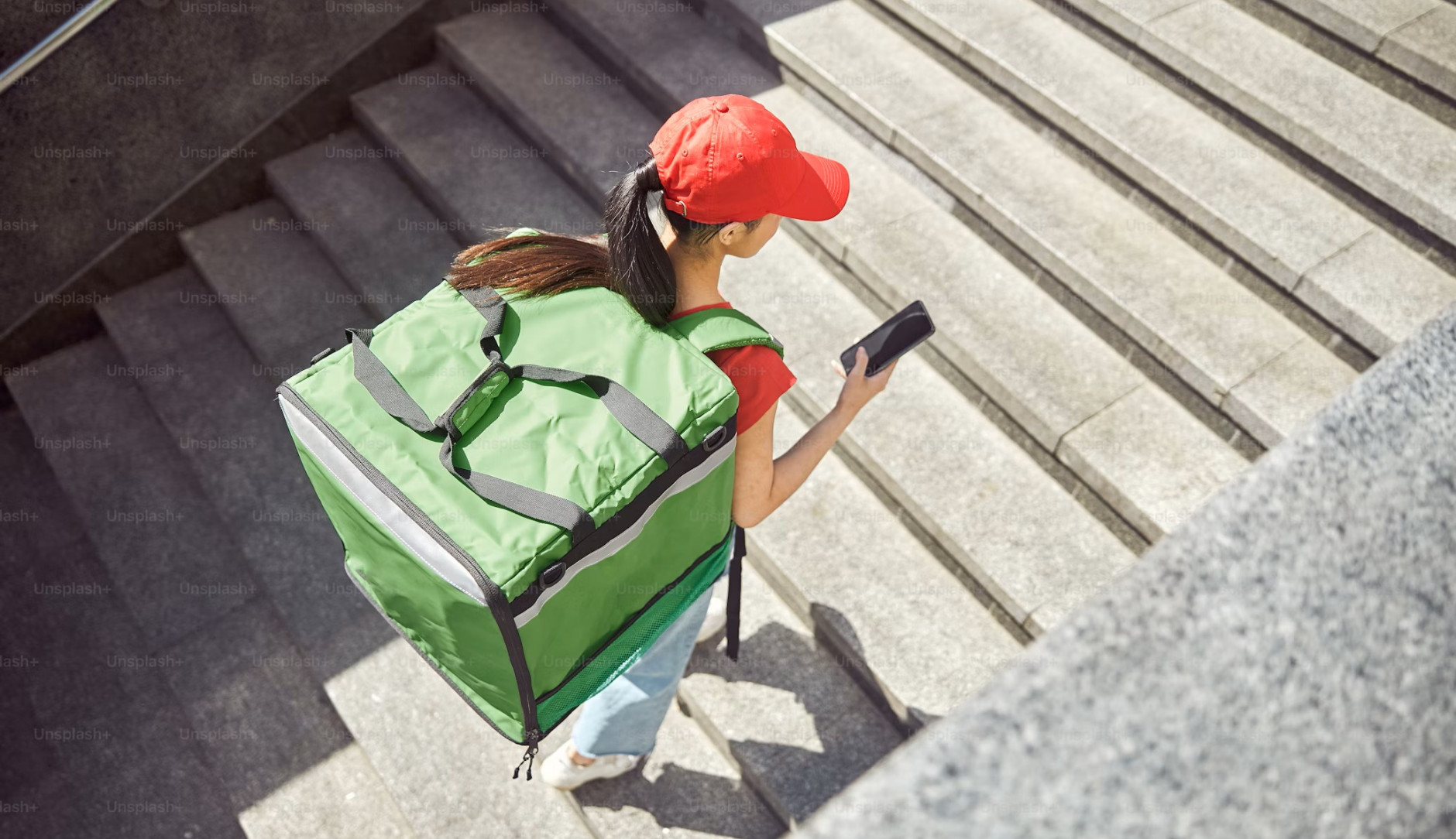 female delivery person walking upwardss on a stairway