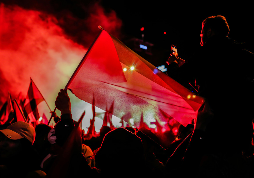 People with a Palestinian flag celebrating at night