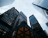 Photo of several high.rise buildings taken from below and looking at the sky