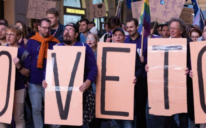 Photo of Volters holding posters that say 